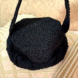VINTAGE BLACK EVENING BAG ADORNED WITH BEADS AND IS CARRIED IN UNIQUE WAY
